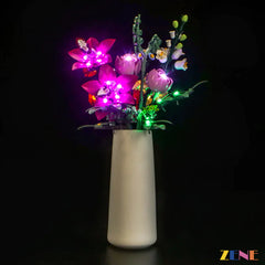 Full view of LEGO Pretty Pink Flower Bouquet #10342 in a vase, illuminated with multicolor LED lights from the ZENE light kit.