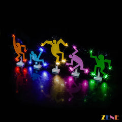 Colorful LED dancing figures on stands with Zene branding against a dark background